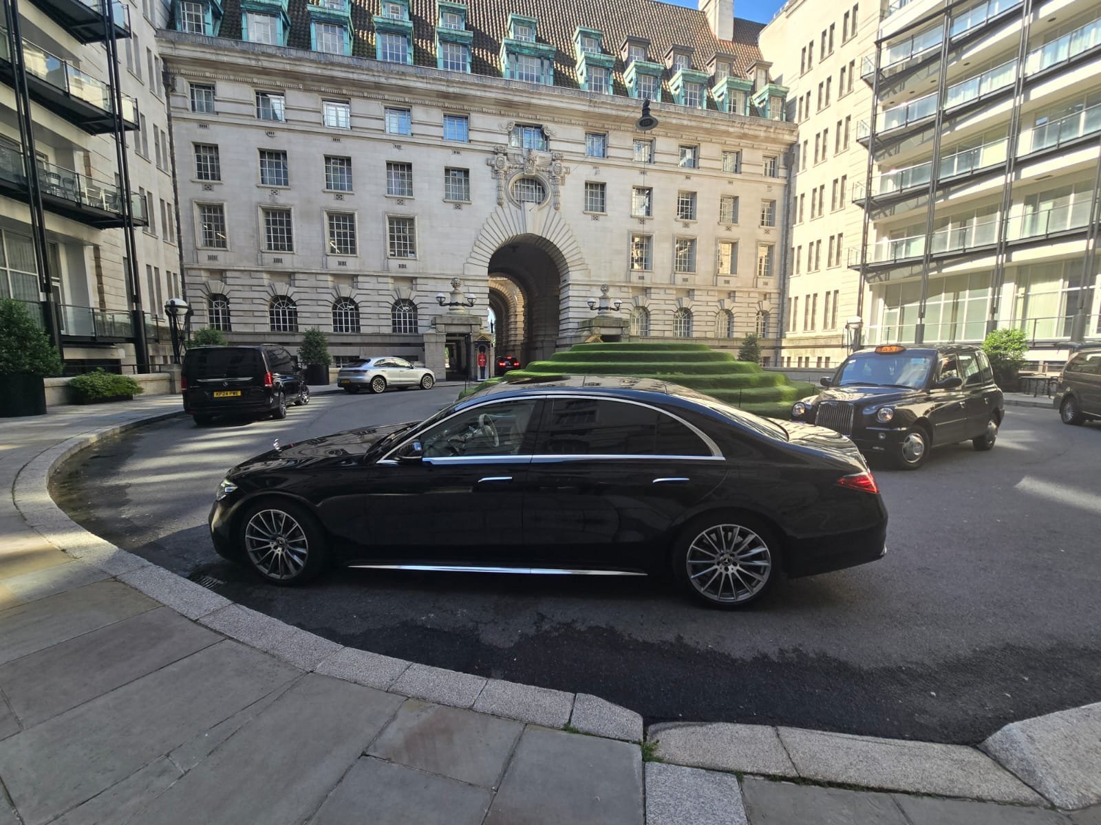 Black Mercedes-Benz chauffeur car on a central London street.
